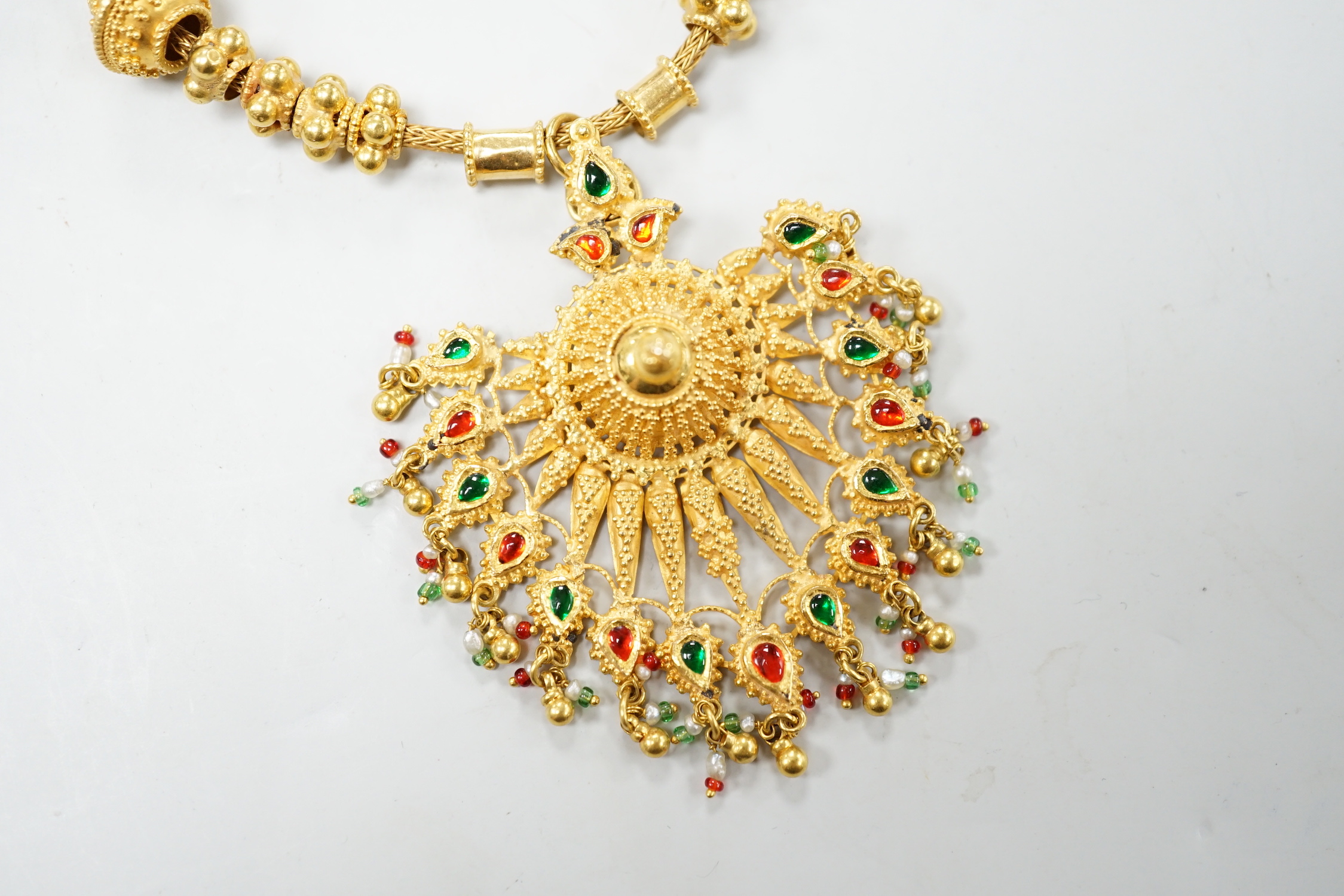 An Indian yellow metal two colour enamel and seed pearl set drop pendant necklace, overall, 45cm, gross weight 40.5 grams.